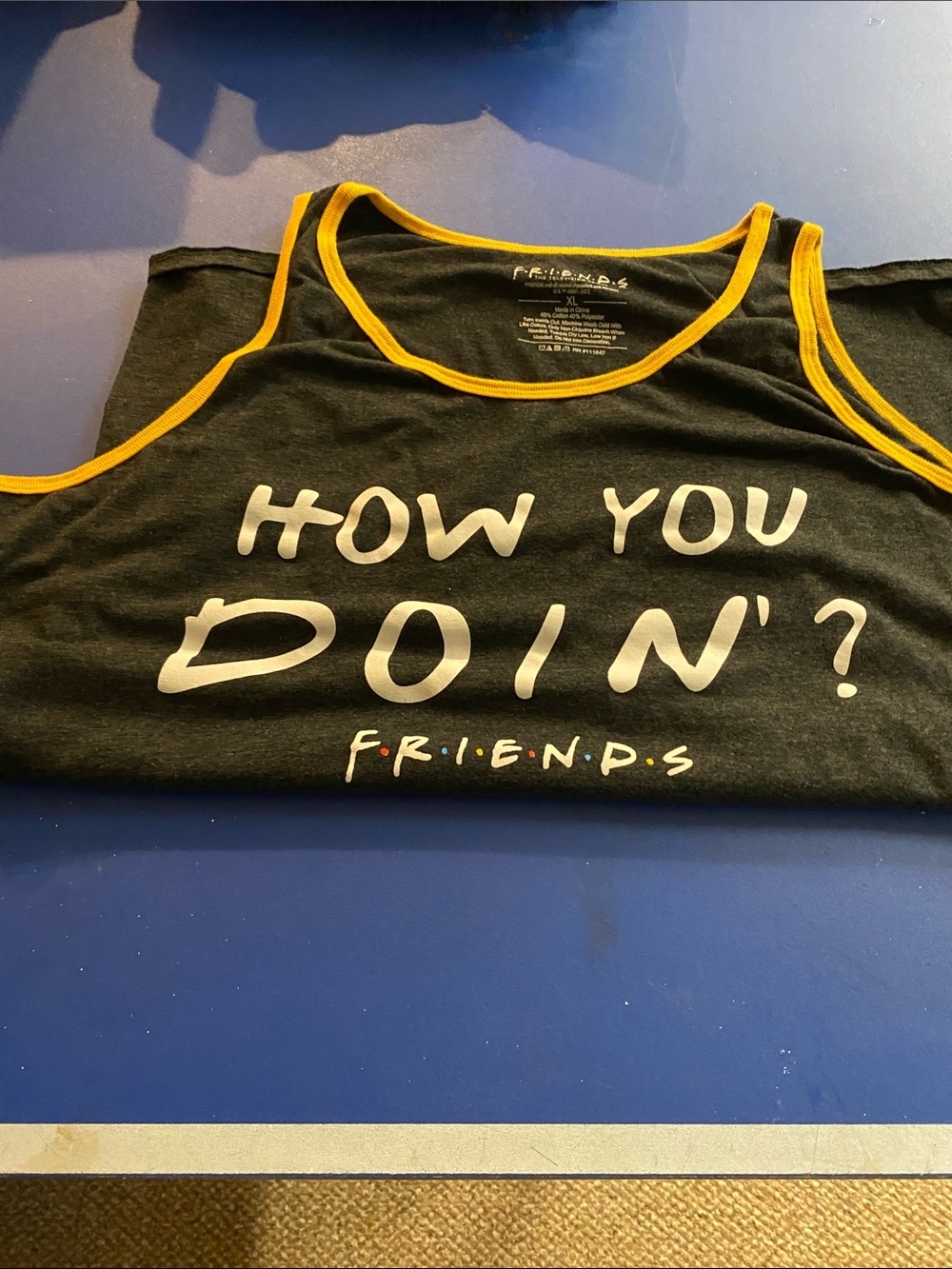 FRIENDS Black Tank Top with Yellow Trim and 'How You Doin'?' Print